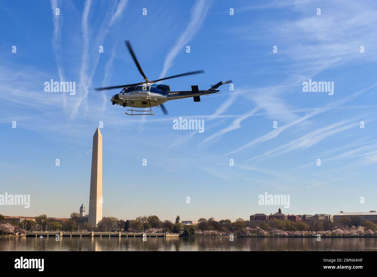 U.S. Park Police helicopter over the Tidal Basin and Washington Monument in Washington, D.C. 21 Mar. 2023 Stock Photo