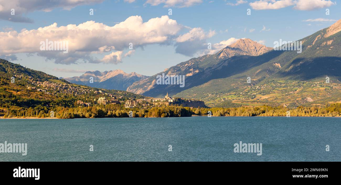 Summer panoramic view of Durance Valley with town of Embrun and Serre-Poncon Lake. Hautes-Alpes, French Alps, France Stock Photo