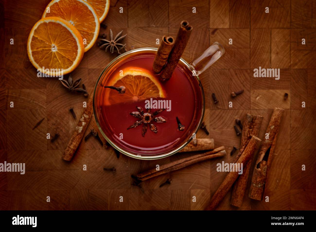 A top view of a pot of mulled wine on a rustic wooden table Stock Photo