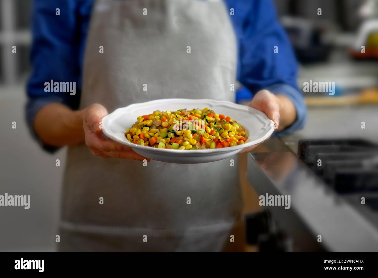 A chef showcasing a tasty oven-roasted vegetable dish Stock Photo - Alamy