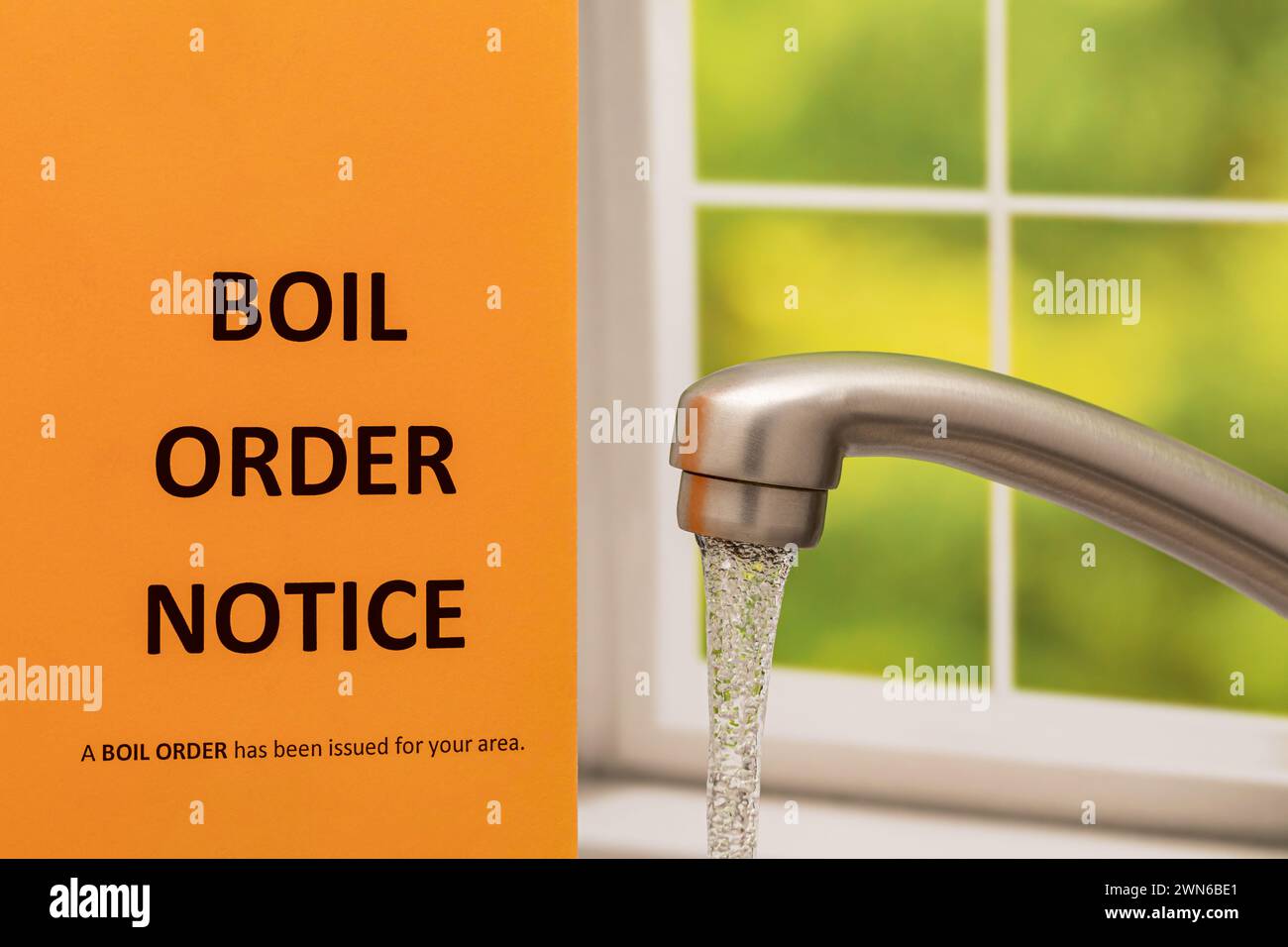 Boil order notice and kitchen faucet. Clean, contaminated, dirty or broken drinking water supply concept. Stock Photo