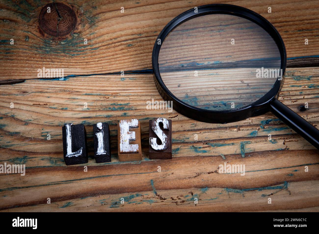 LIES. Alphabet letters on wood texture background Stock Photo - Alamy