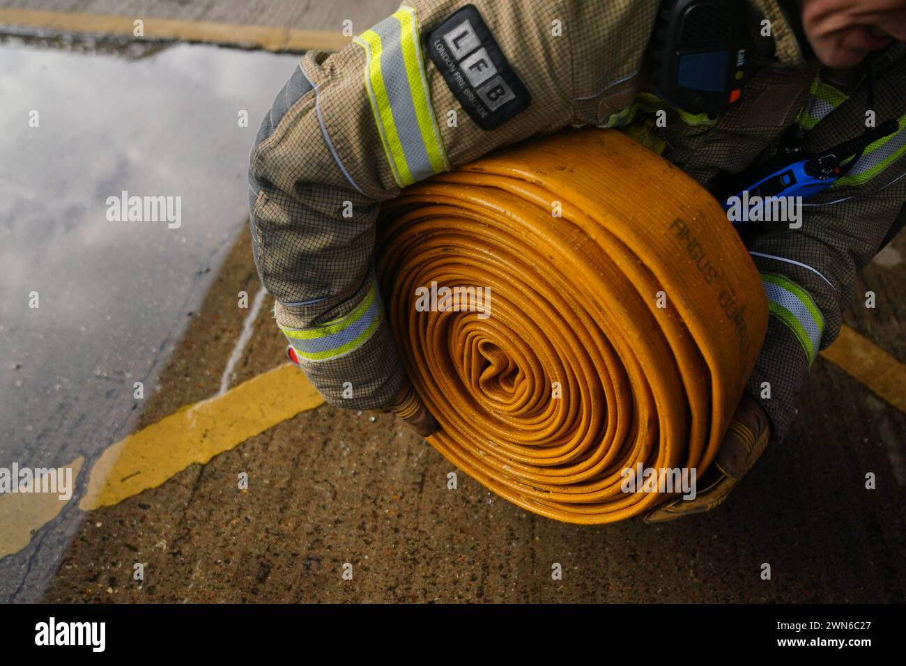 Firefighter officers run through a practice drill during a London Fire Brigade facility at Poplar Fire Station in London. Picture date: Friday December 1, 2023. Stock Photo