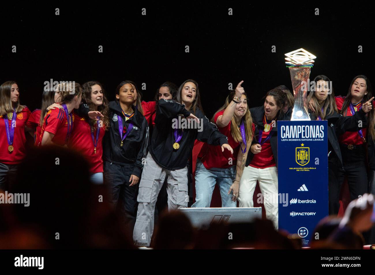 A group of players from the Spanish women's soccer team celebrate on stage next to the Nations League trophy at the Vista Alegre palace in Madrid. The Spanish national women's football team celebrates with its fans the title of champions of the Women's Nations League after beating France yesterday by 2 goals to 0. Stock Photo
