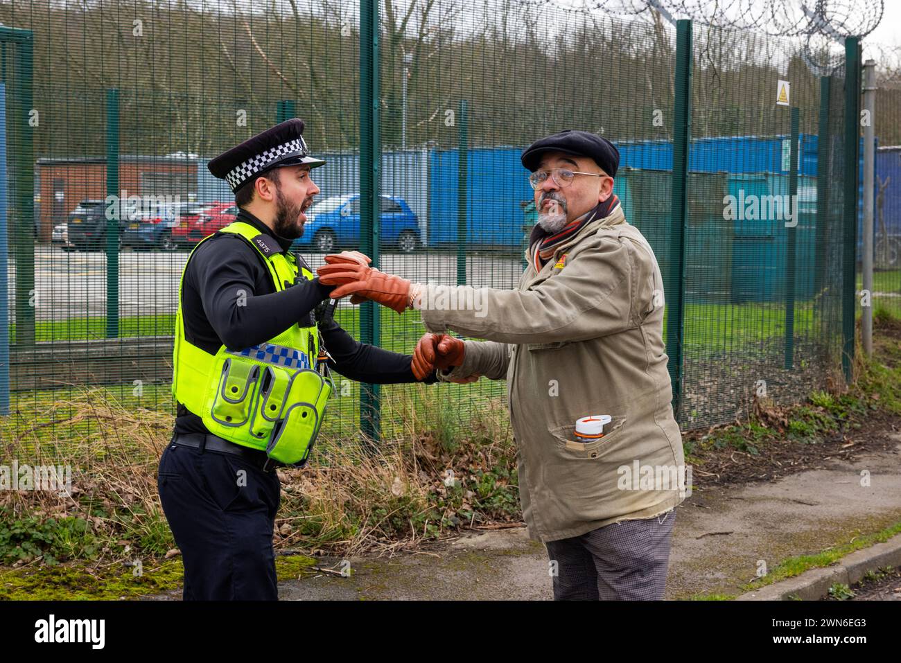 Shipley, UK. 29 FEB, 2023. Police move a pro palestine protestor away from the gates of Teledyne Shipley. No further action was taken . Credit Milo Chandler/Alamy Live News Stock Photo