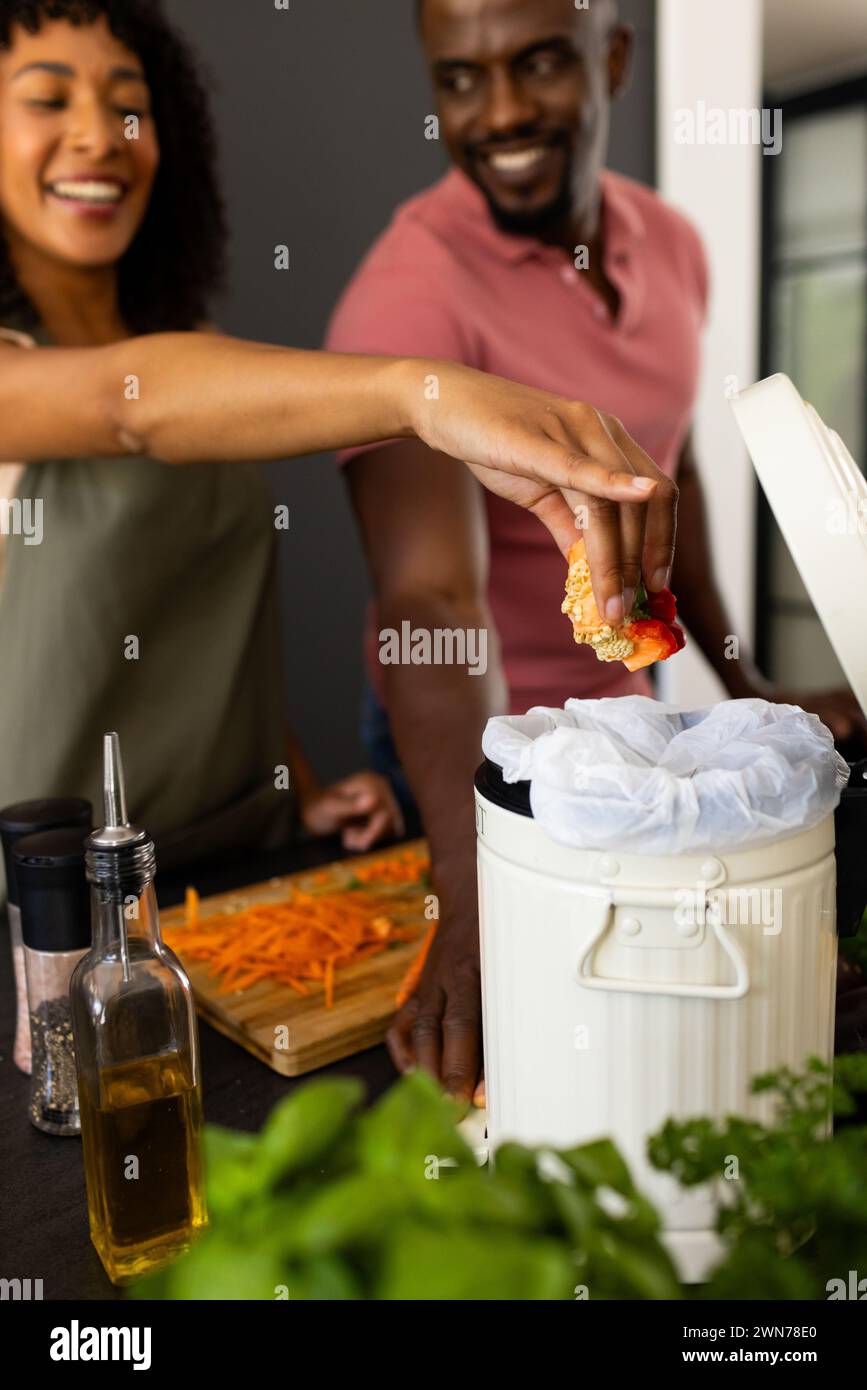 Biracial African American couple are smiling while cooking together at ...