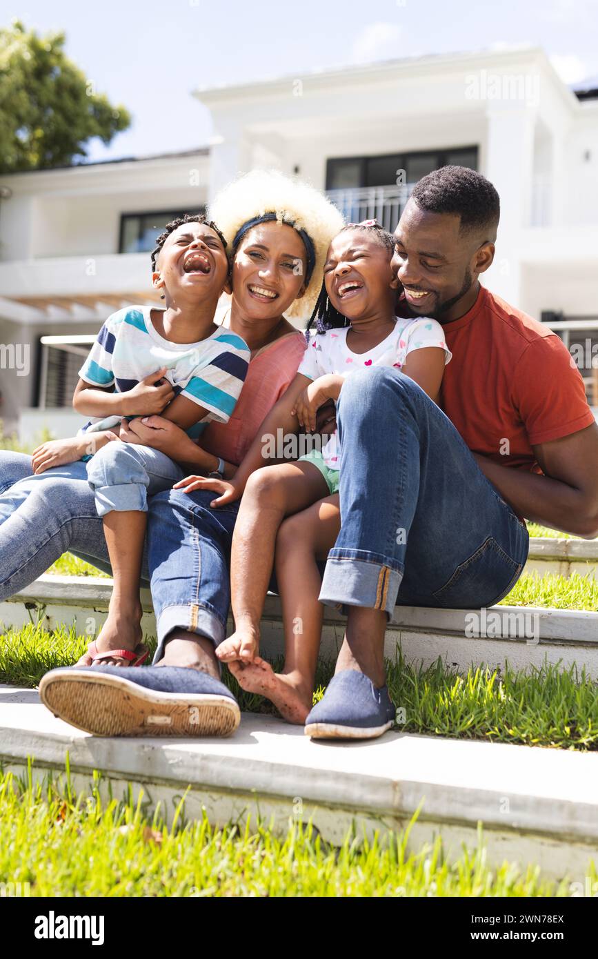 African American family enjoys a sunny day outdoors, laughter fills the air Stock Photo