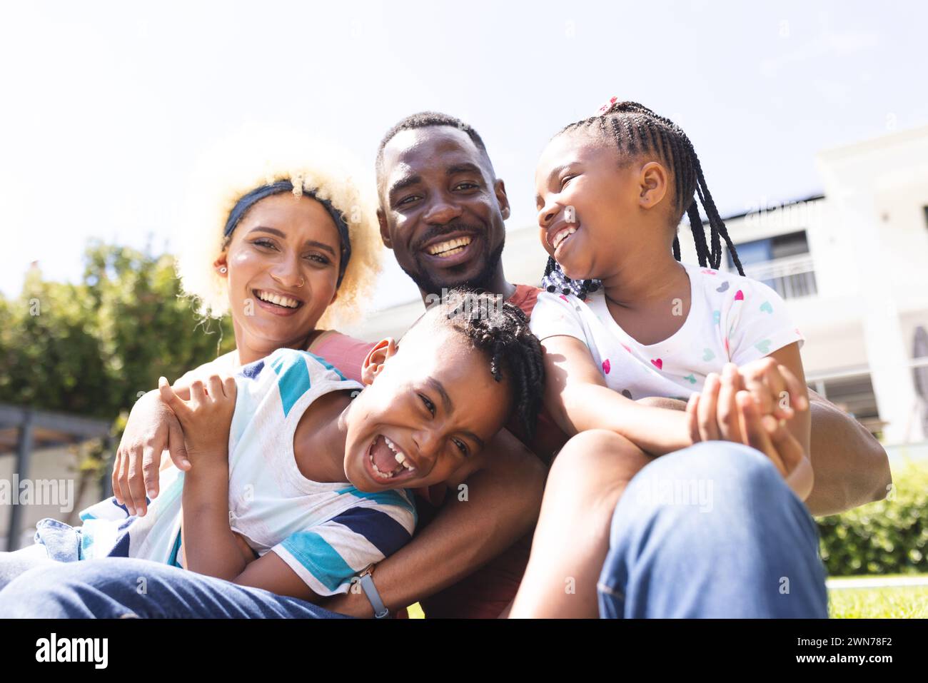 Diverse family enjoys a sunny day outdoors, sharing laughter and joy Stock Photo