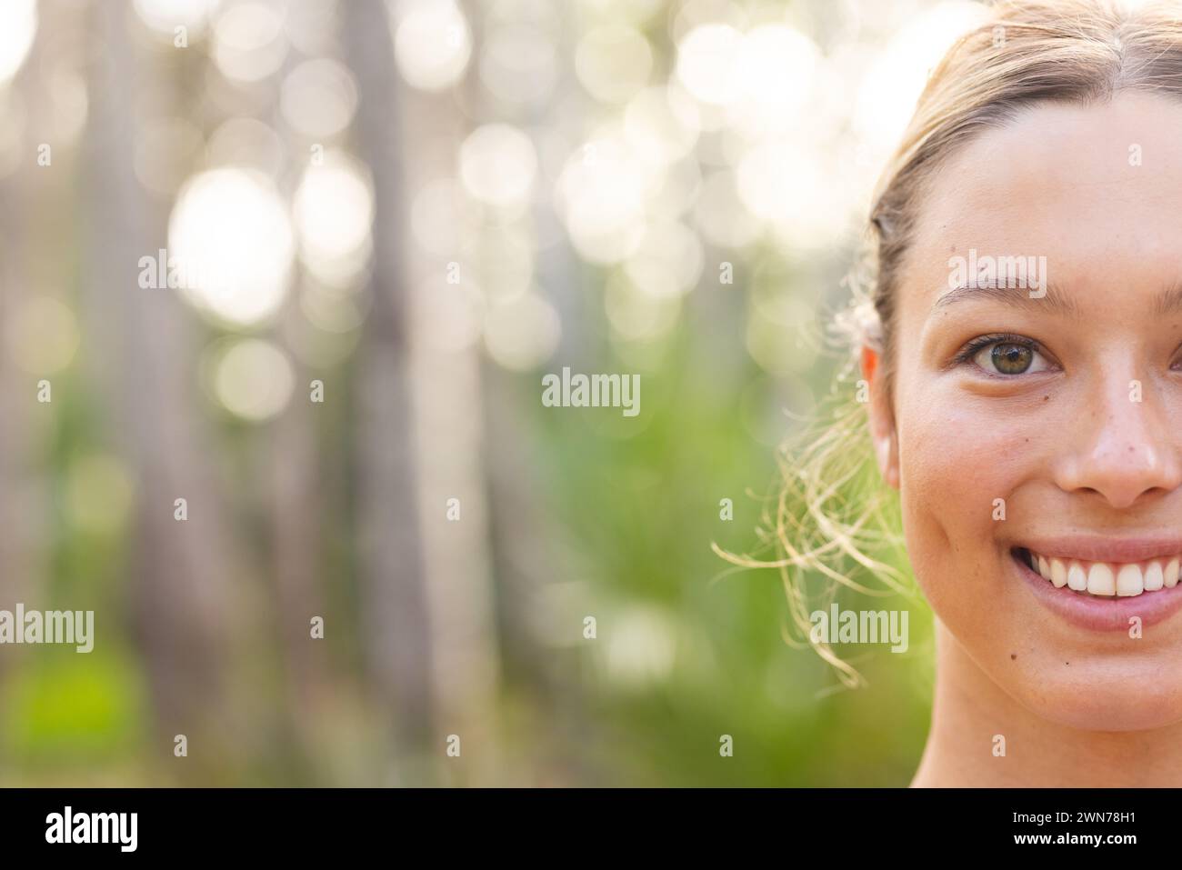 Young Caucasian woman with a joyful expression, outdoors on a hike, with copy space Stock Photo