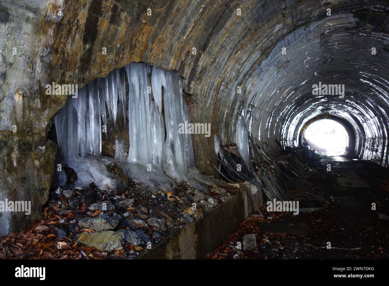Icicles breaking through wall of disused road tunnel, Nagano Prefecture, Honshu, Japan Stock Photo
