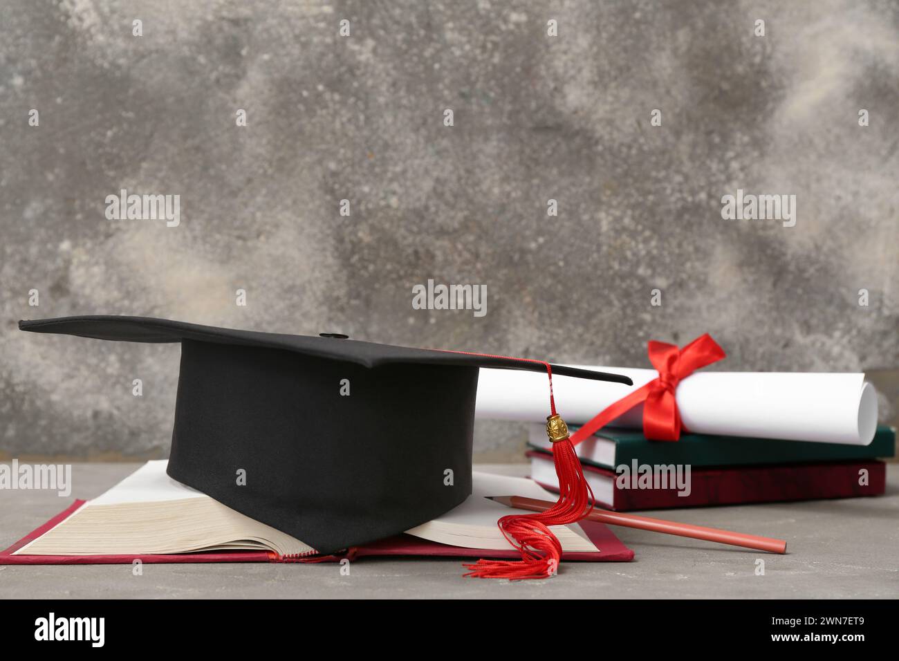 Mortar board with diploma and notebooks on grey background Stock Photo ...