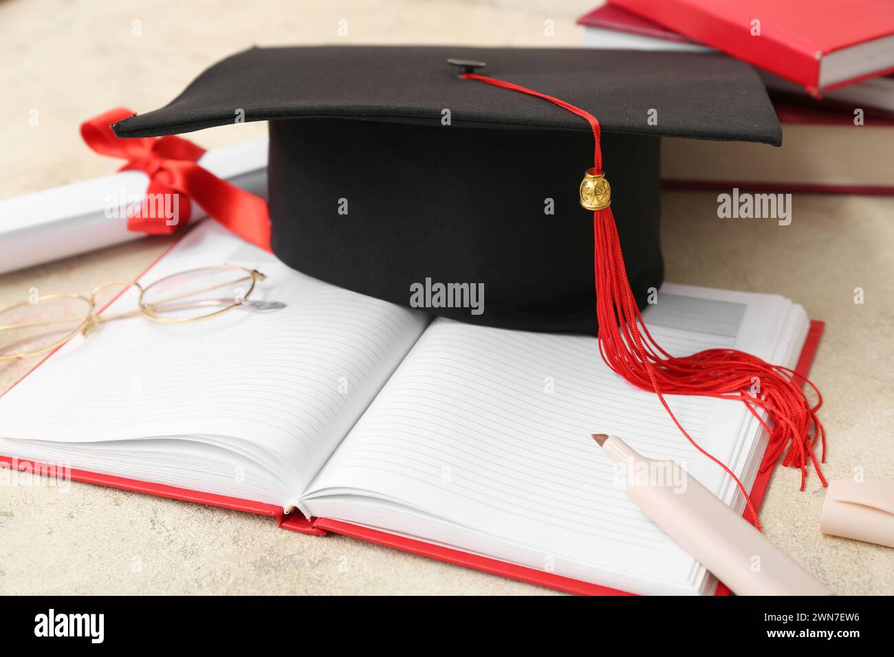 Mortar board with diploma and notebooks on beige background Stock Photo ...