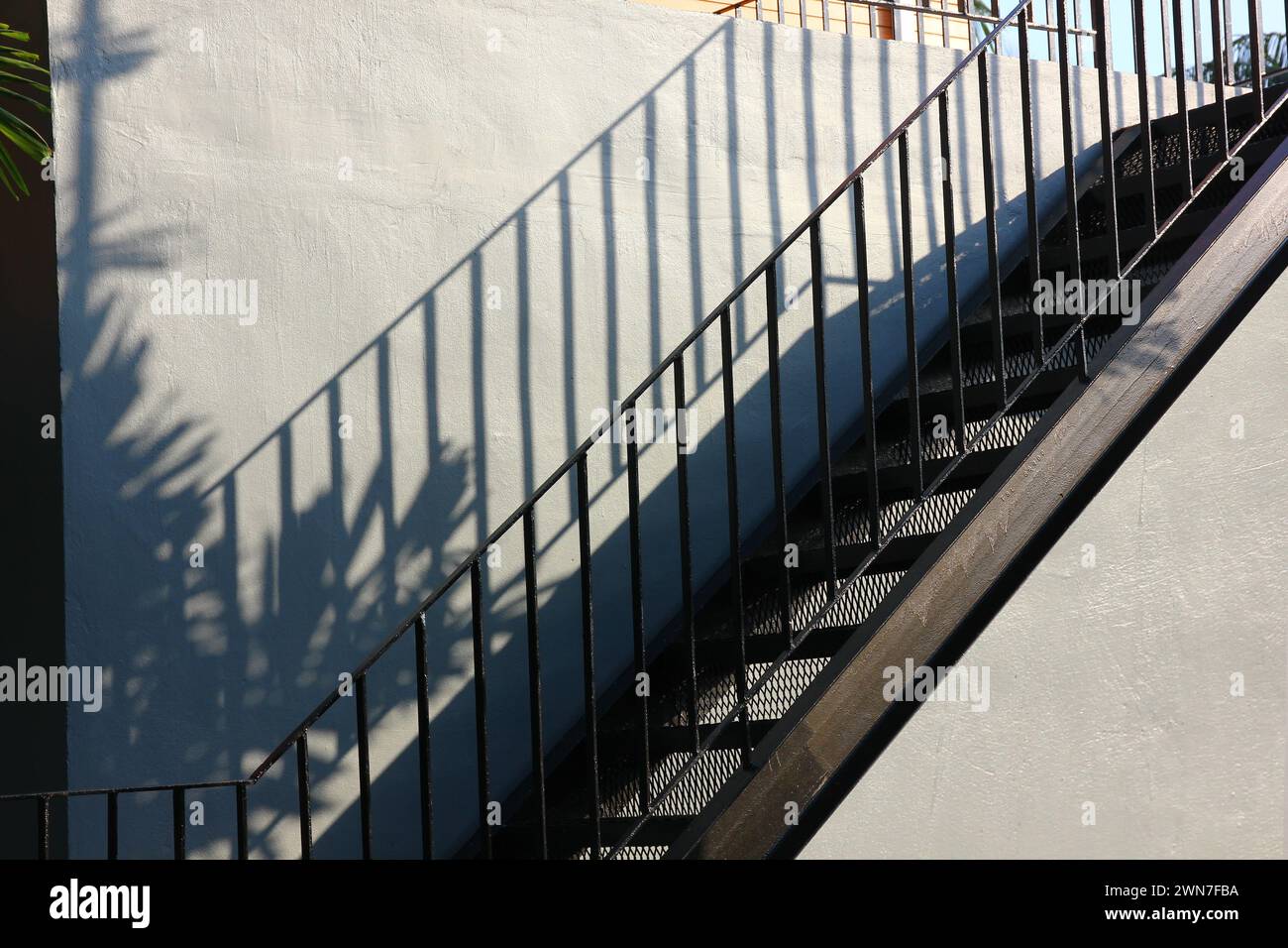 black iron stairs on cement wall Stock Photo