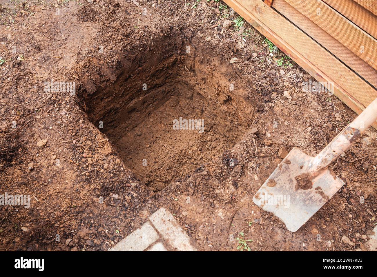 Hole in a soil, prepared for planting or construction, pit in a ground ...