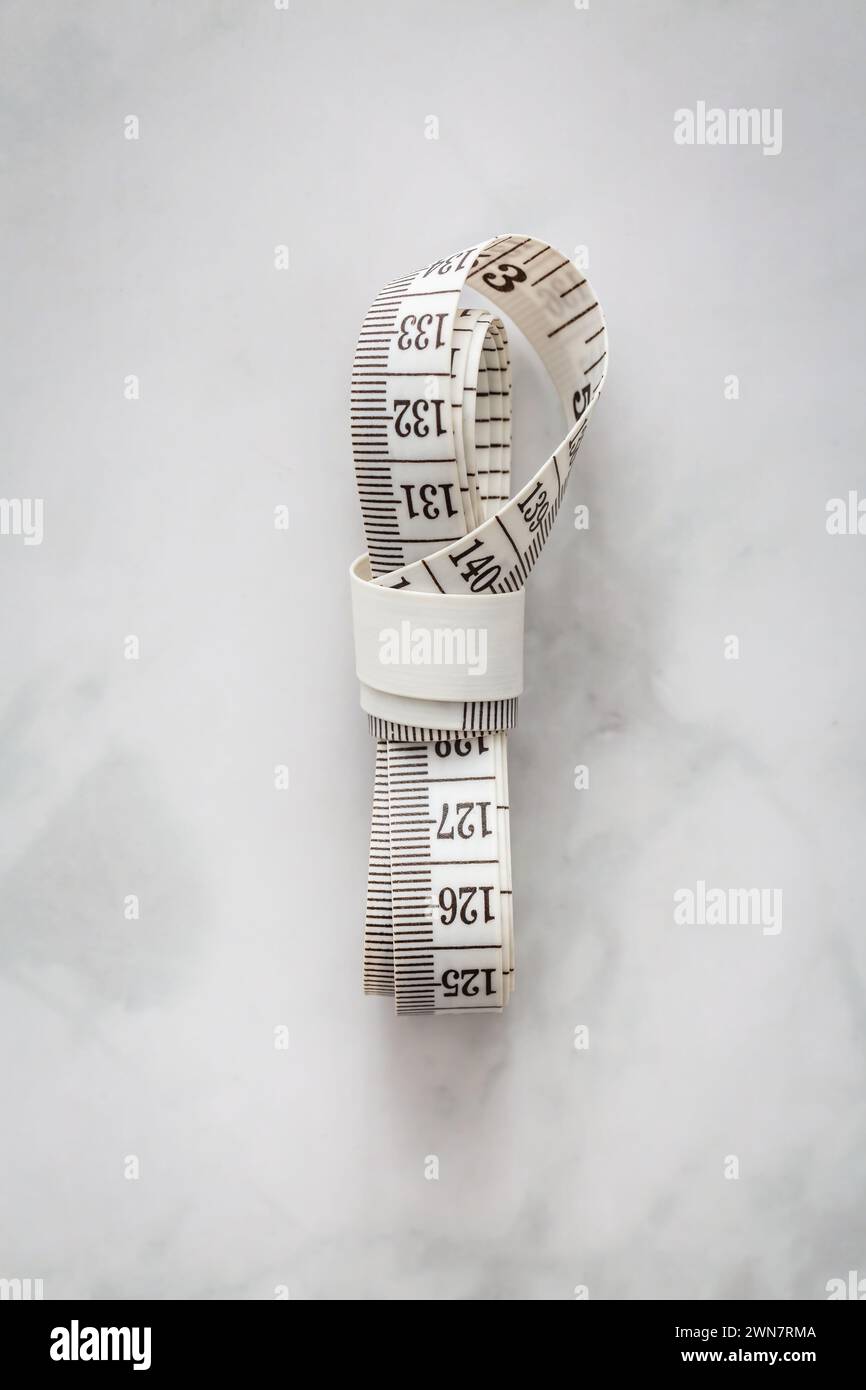 Tape measure on marble table Stock Photo