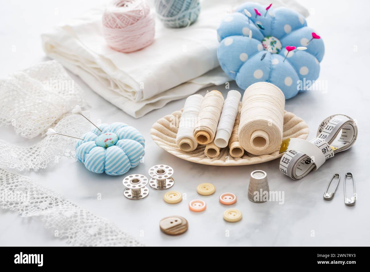 Still life of sewing utensils with buttons, threads, pins Stock Photo