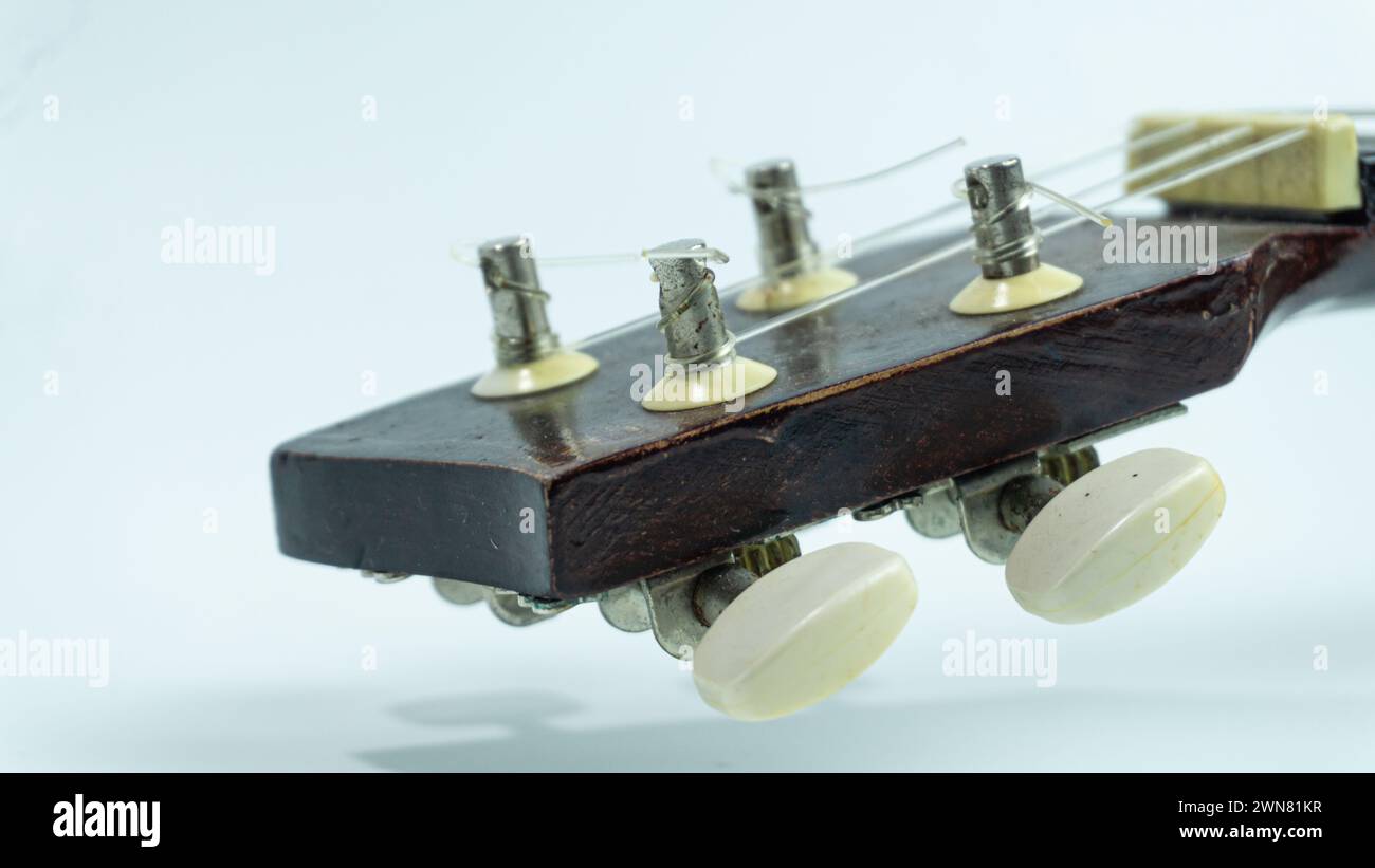 Ukulele head with 4 tuners and strings Stock Photo