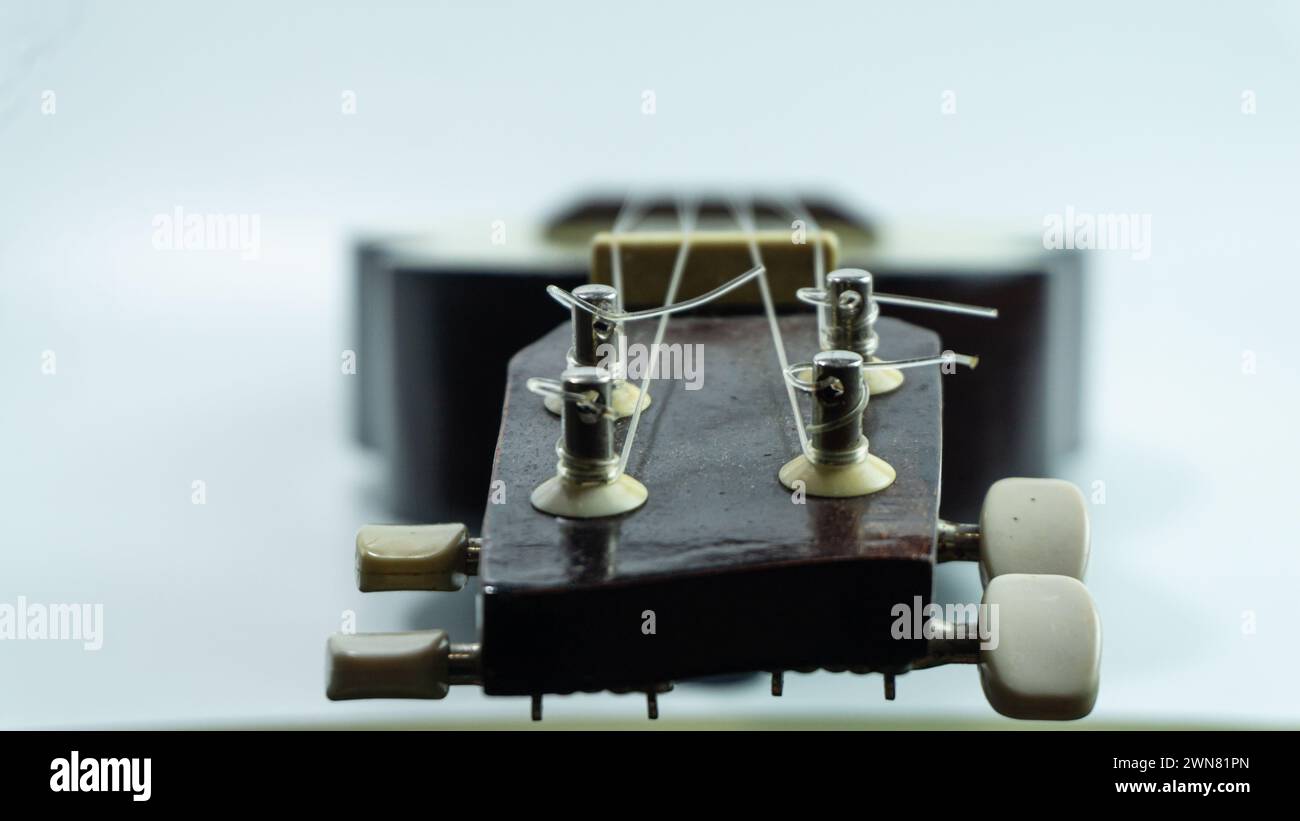 Ukulele head with 4 tuners and strings Stock Photo