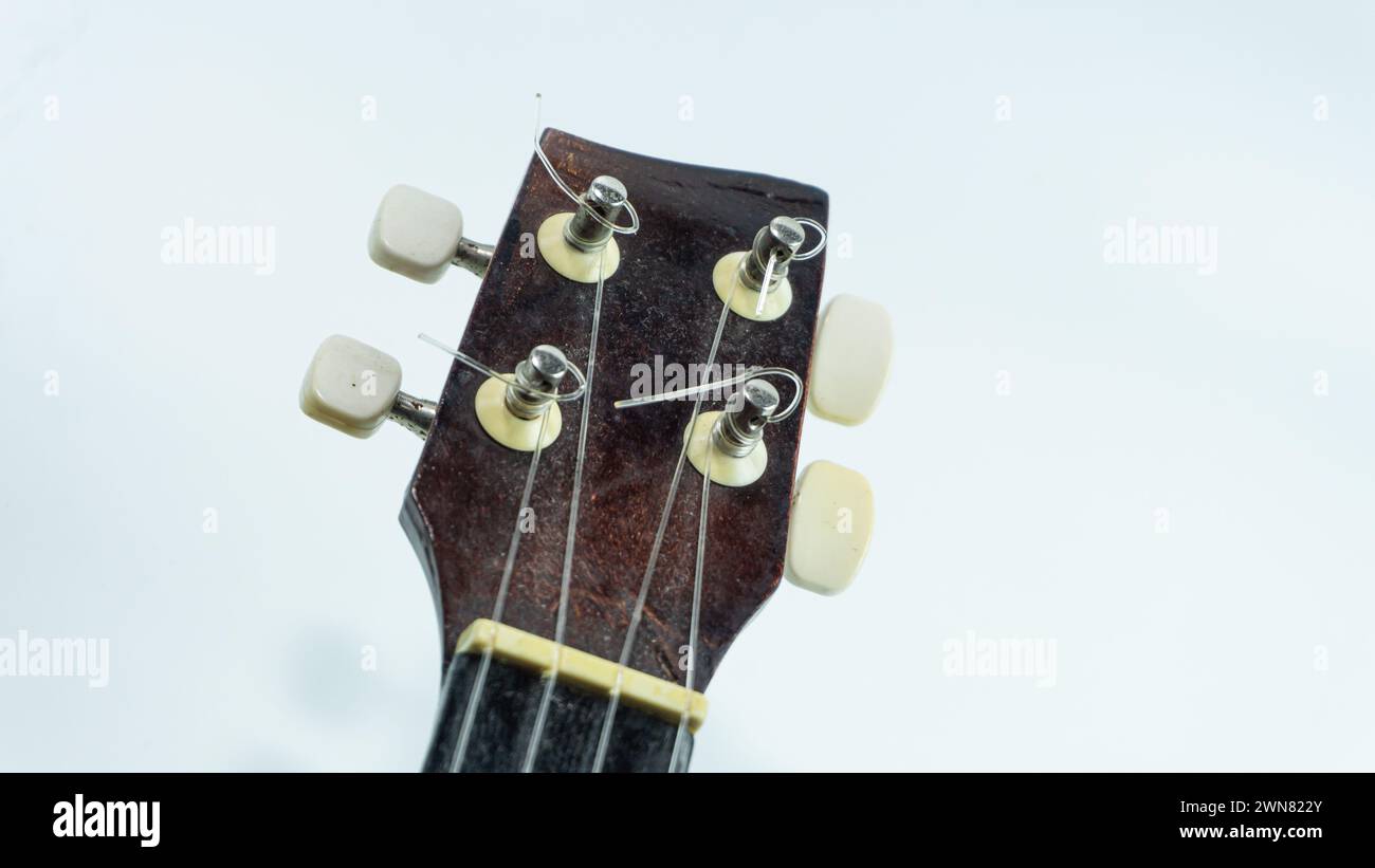 Ukulele head with 4 tuners and strings Stock Photo