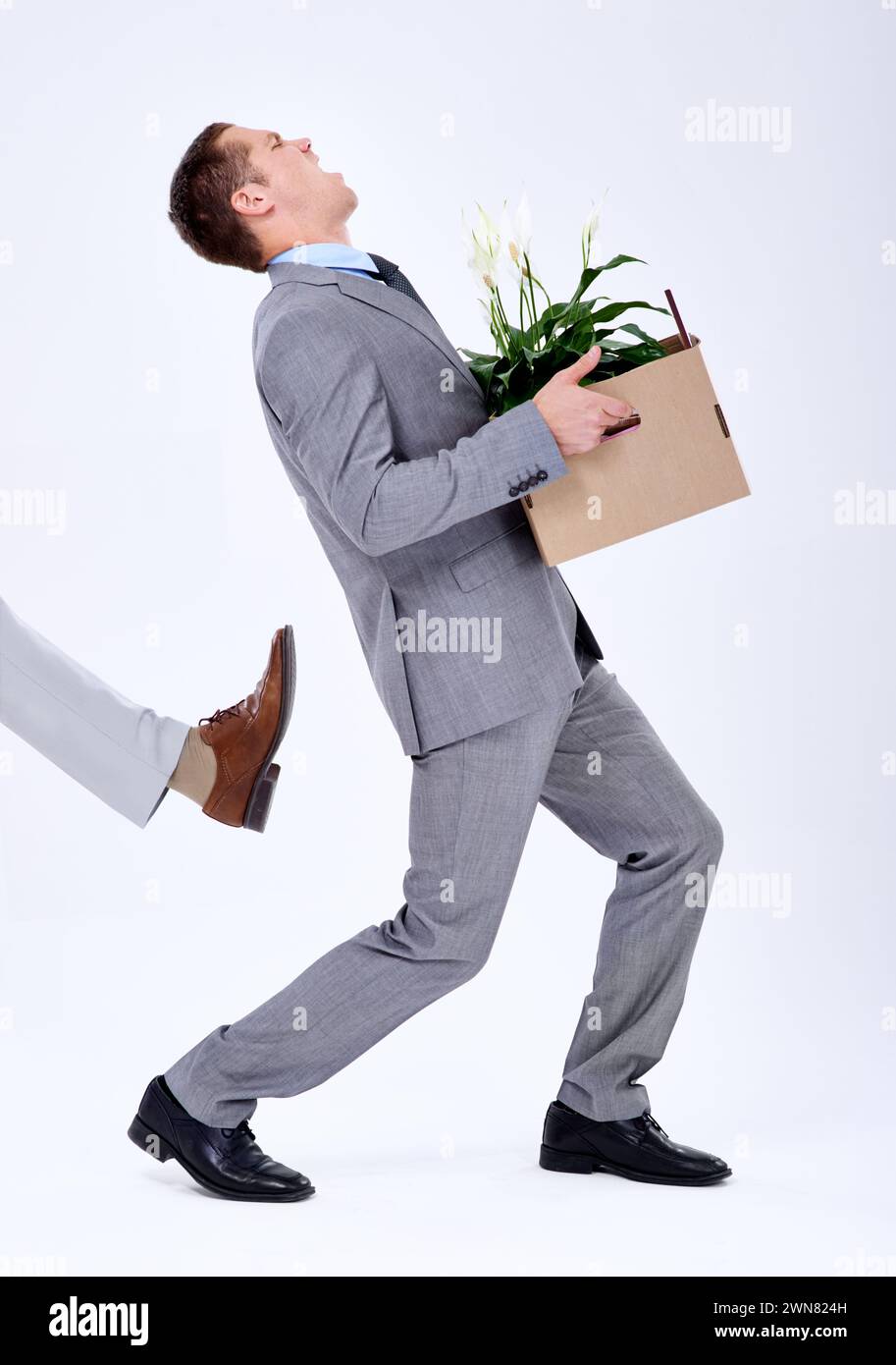 Businessman, unemployed or fired by boss in company with box, rejection or sad with career crisis. Salesman, risk or mental health for kick or income Stock Photo