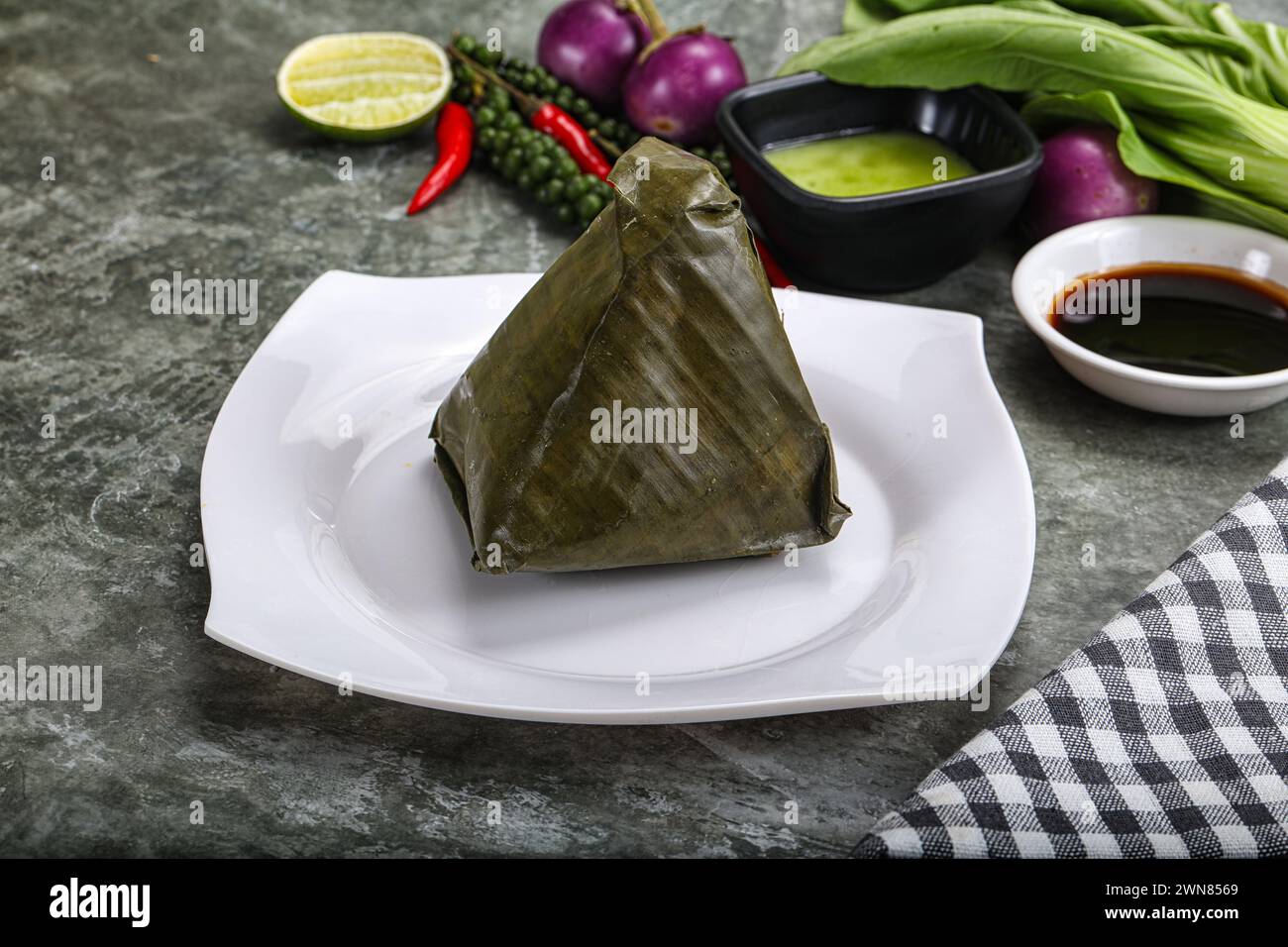 Asian cuisine - rice with filling wrapped in banana leaf Stock Photo ...