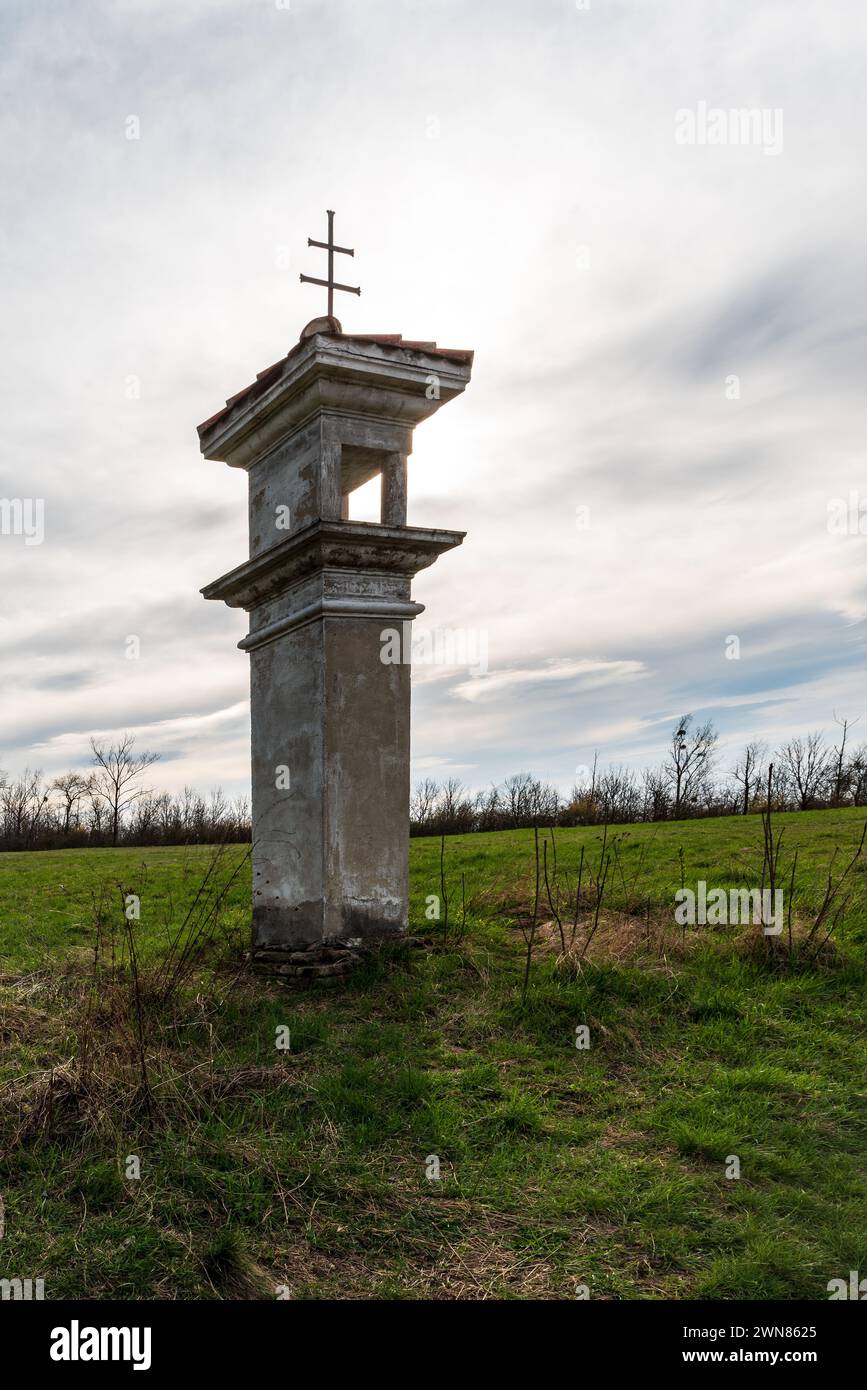 Wayside shrine on meadow above Perna village in Czech republic during springtime Stock Photo
