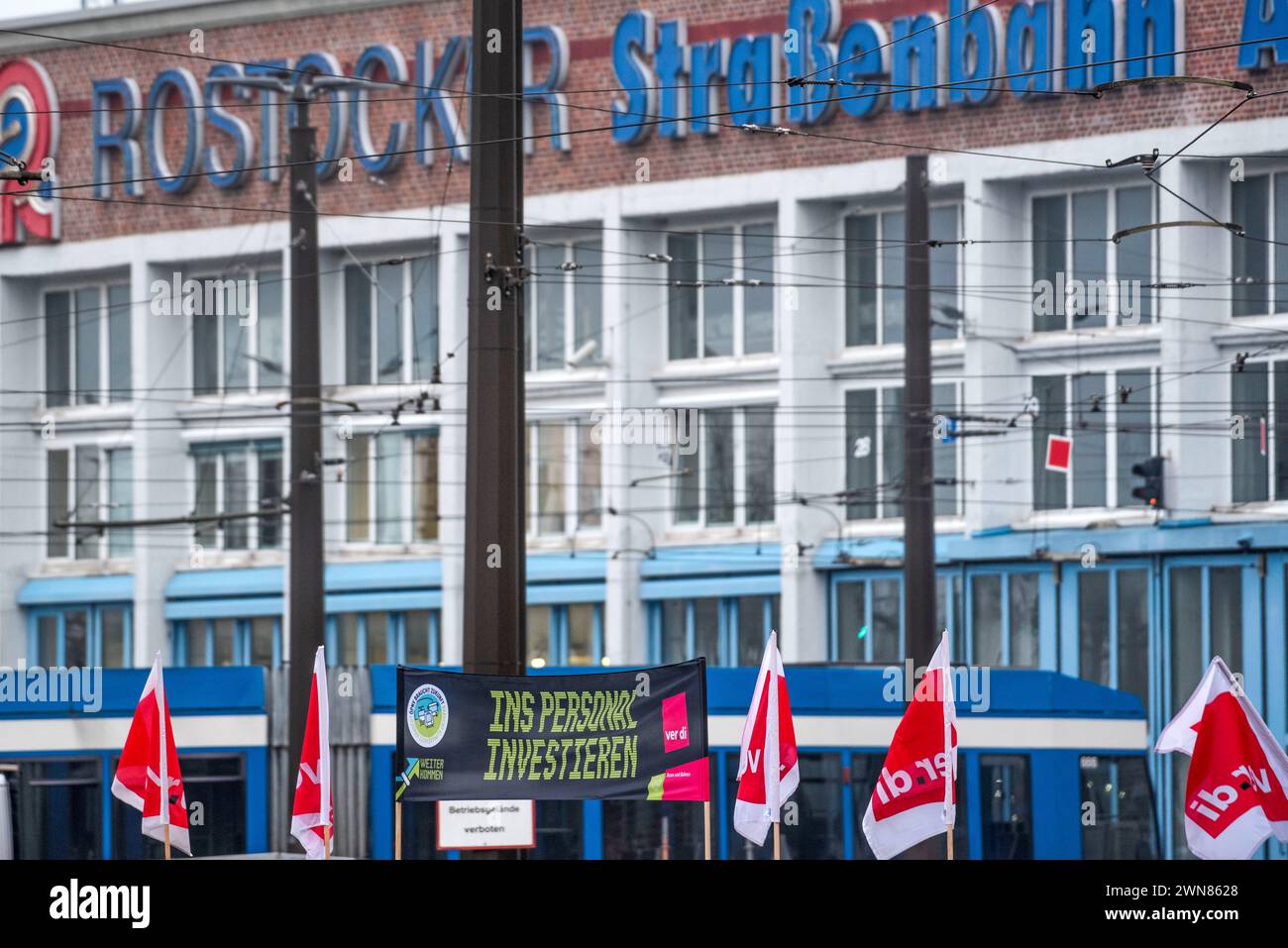 Rostock, Germany. 01st Mar, 2024. A banner with the inscription "Invest