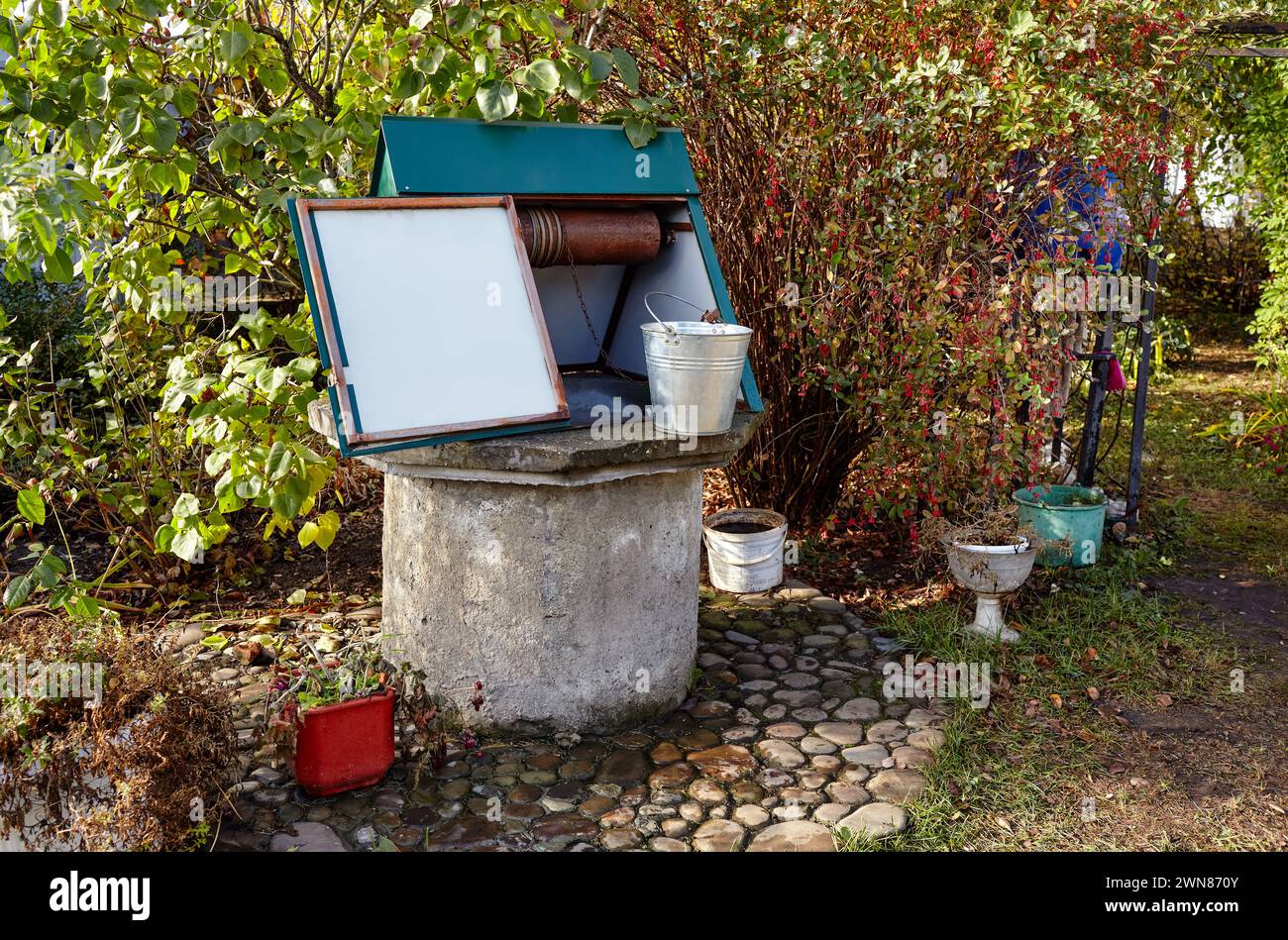 Old stone well with bucket hi-res stock photography and images - Alamy