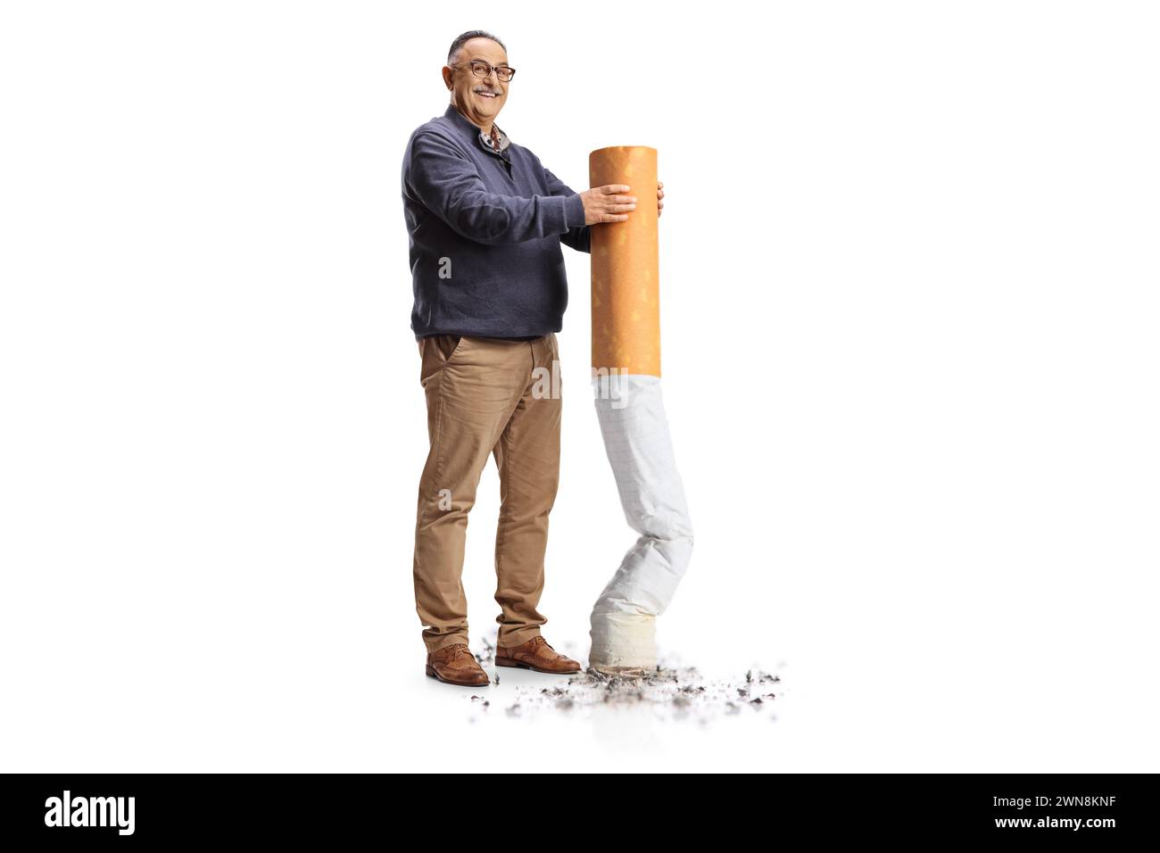Full length portrait of a happy mature man putting off a big cigarette isolated on white background, give up smoking concept Stock Photo