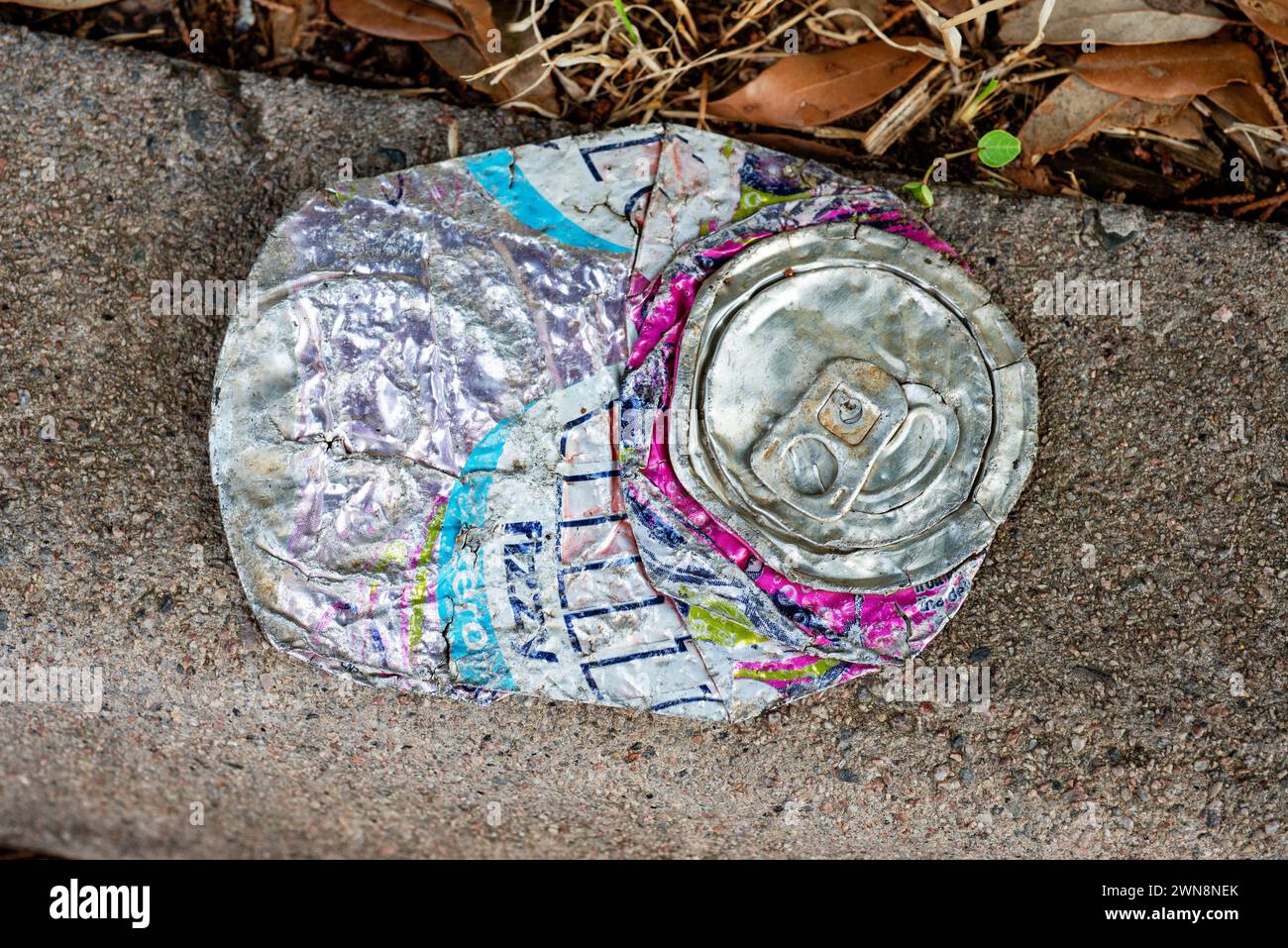Flattened soft drinks can on a roadside Stock Photo