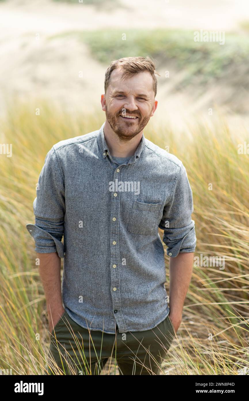 Portrait of middle aged man smiling while at the beach Stock Photo