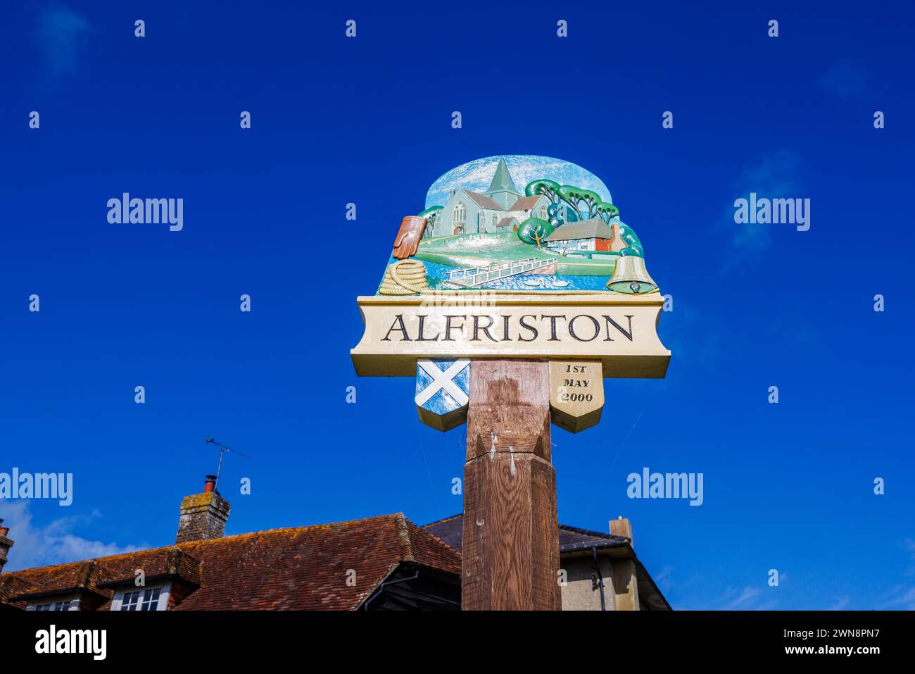 Painted name sign dated 1st May 2000 of Alfriston, a pretty historic village in the Wealden district of East Sussex Stock Photo