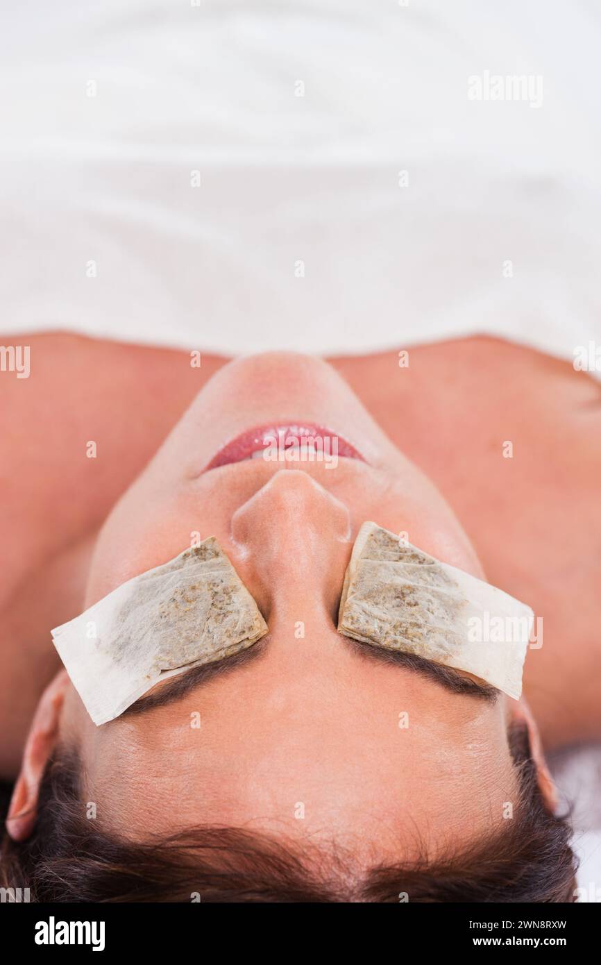 Close-up view of tea bags on woman's eyes Stock Photo