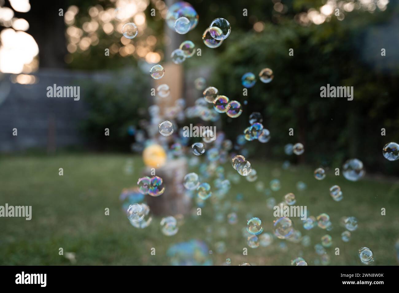 Bubbles Floating In The Air During Summertime Play Stock Photo