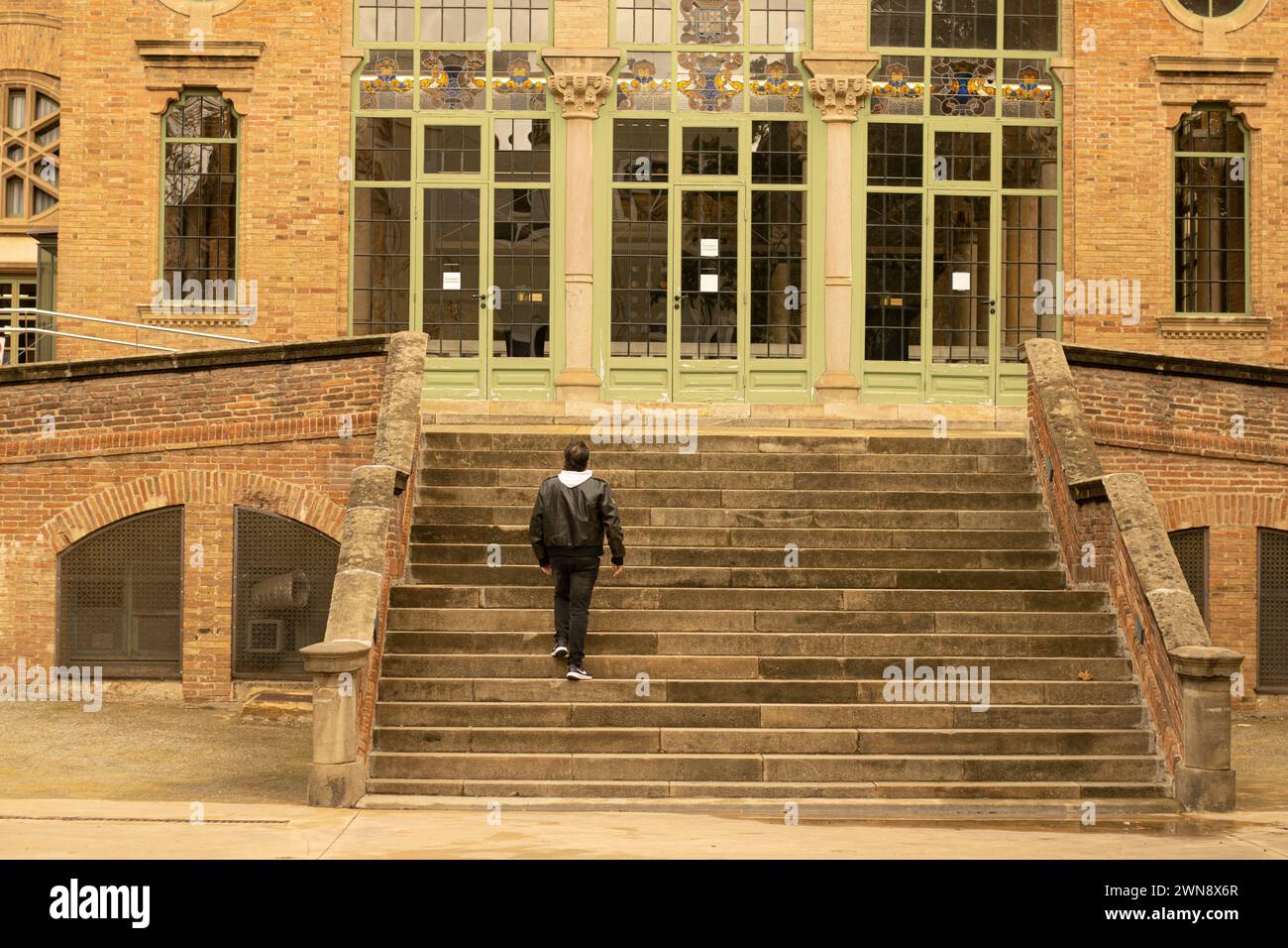 man climbing stairs in emblematic building in Barcelona Stock Photo