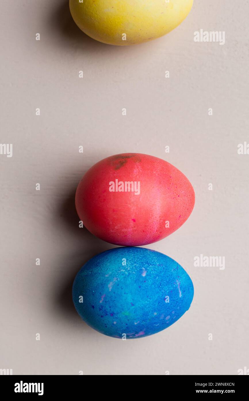 Three dyed Easter eggs  against a pink backdrop Stock Photo