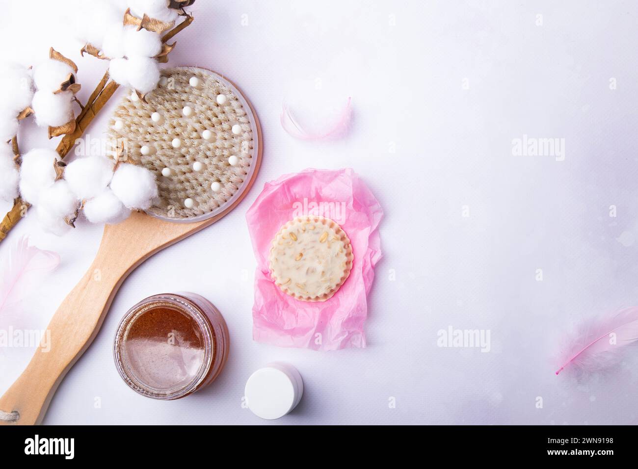 Elegant self-care beauty products for body care, dry brush technique, wooden brush, natural soap, scrub Stock Photo