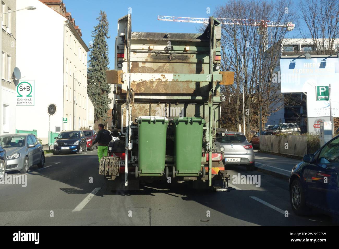 a garbage man at the waste collection, waste separation and recycling garbage man at the waste collection Stock Photo