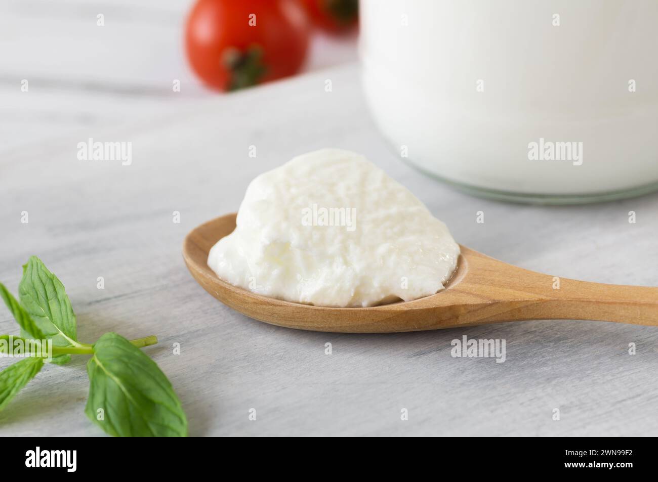 homemade-yogurt-with-cream-in-a-wooden-spoon-healthy-food-stock-photo