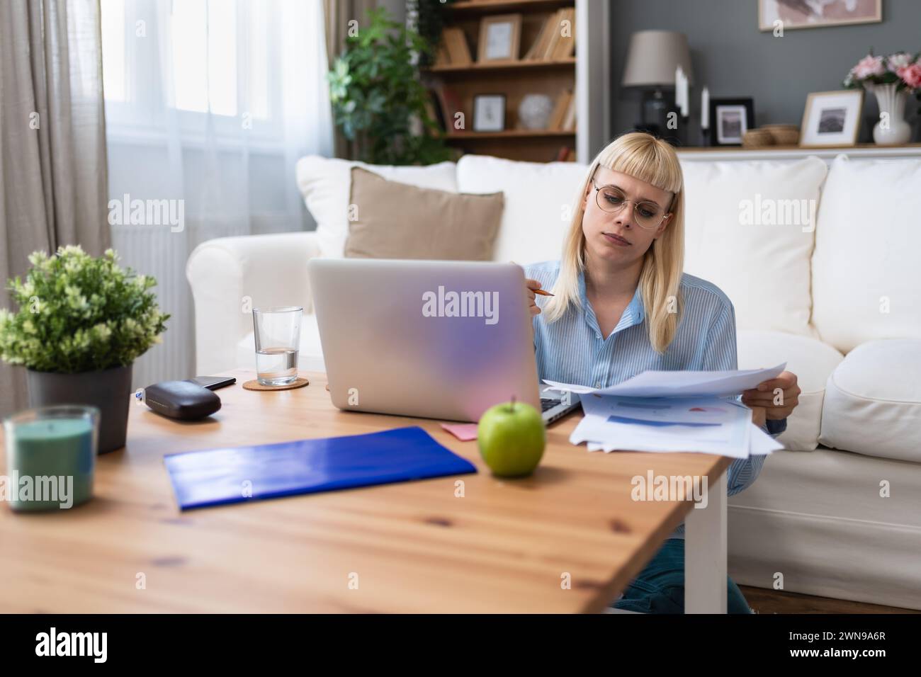 Young business woman freelance expatriate financial and digital marketing expert in smart casual working at home in home office in smart casual wear c Stock Photo