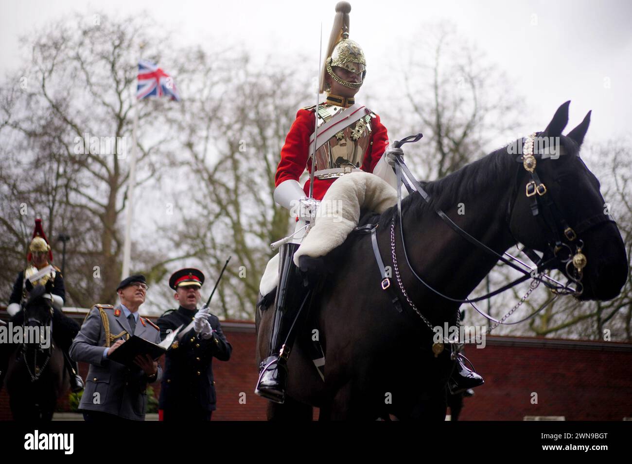 A member of the Life Guards, the most senior regiment of the British Army and part of the Household Cavalry, is judged during the Princess Elizabeth Cup, the annual cup for the best turned out troopers, at Hyde Park Barracks in London. The winners go on to meet King Charles III at the Royal Windsor Horse Show in May when the overall winner is presented with the cup. Picture date: Friday March 1, 2024. Stock Photo