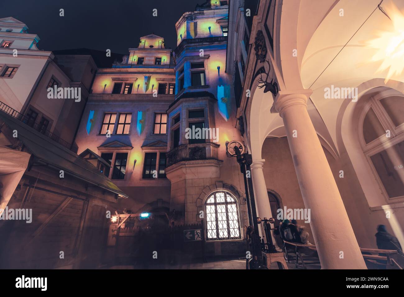 Colourful lights illuminate building facades in an urban night-time setting, Dresden Christmas market Stock Photo