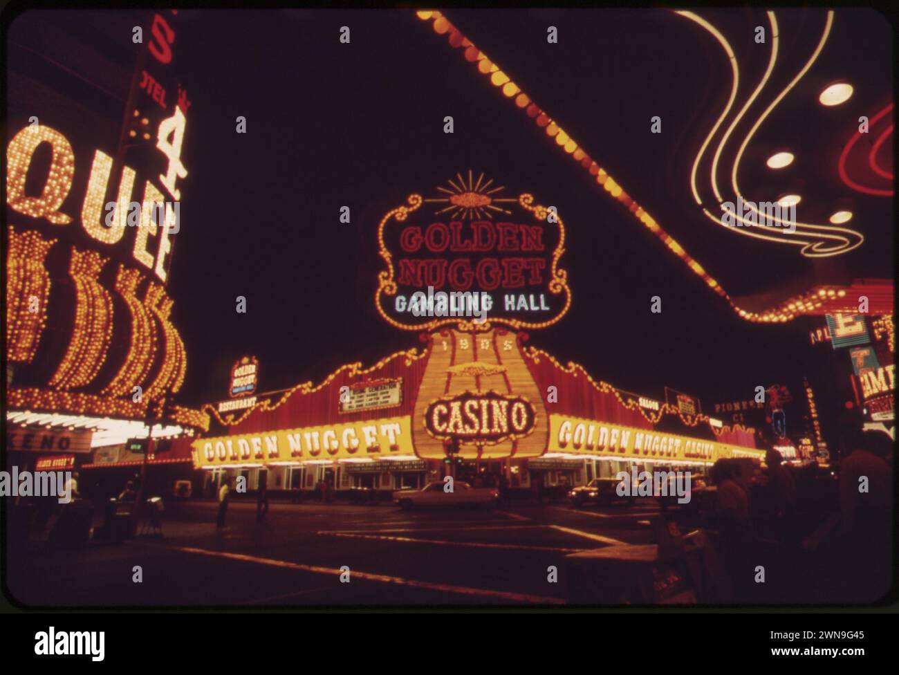 Nighttime lit up neon sign of the Golden Nugget Gambling Hall Casino.  Vintage 1970s Colour photogragh of Vegas street scene, May 1972. Stock Photo
