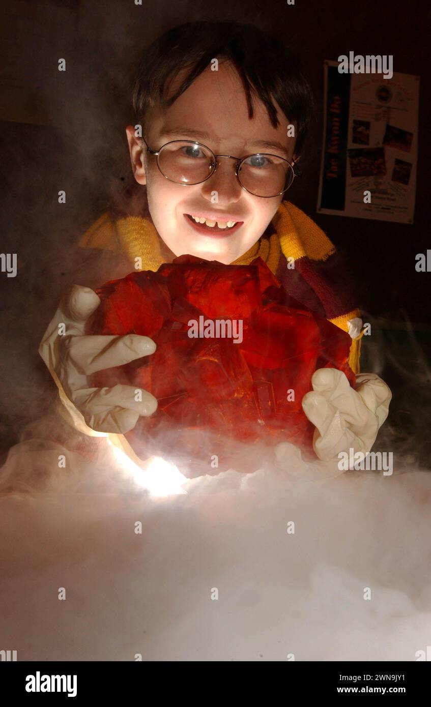 Harry Potter fan James Robbins, eleven, a pupil at Craigentinny Primary School, Edinburgh, gets hold of a giant blood red crystal, like the Philosophers Stone in the Harry Potter movie which is released today, at The University of Edinburgh's Chemistry Department today, Friday 16/11/01.  As part of Chemistry Week which starts today James was competing with pupils from throughout Edinburgh and The Lothians in a competition to grow crystals and leapt at the chance to get hold of the giant chrome alum crystal which the University normally keeps locked up in it's museum. Stock Photo