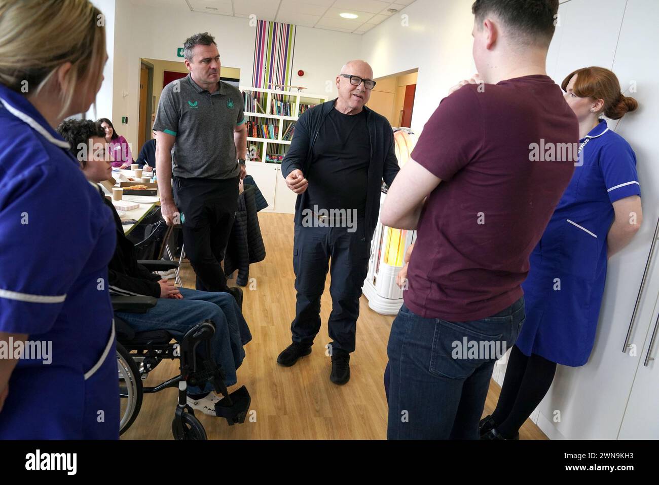 Dire Straits star Mark Knopfler, (centre) and Newcastle United ambassador Steve Harper (left) meet nurses and staff, during a visit to the Teenage Cancer Trust ward, at the Royal Victoria Infirmary, Newcastle. Picture date: Friday March 1, 2024. Stock Photo