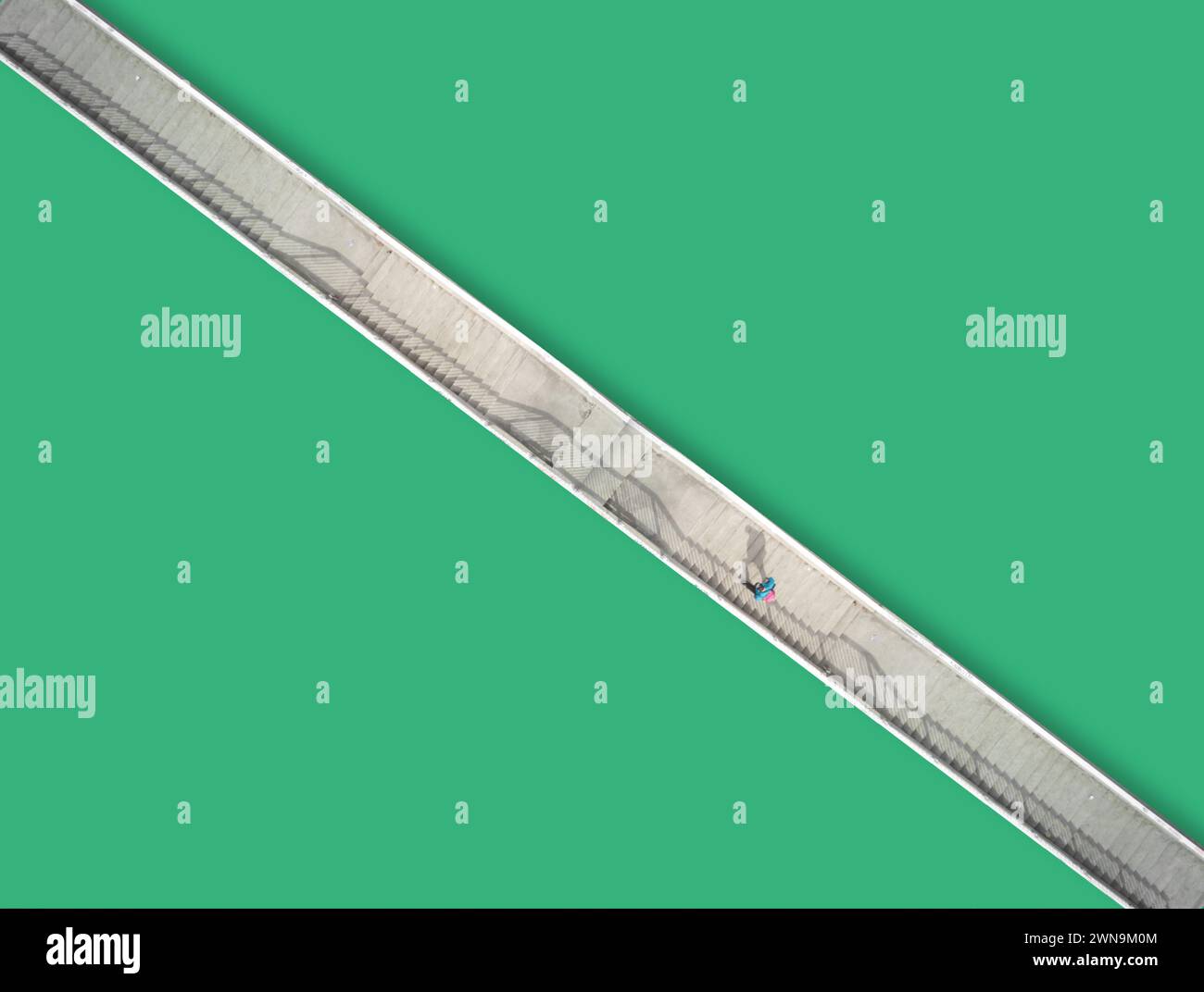 Minimalistic aerial view of a man walking over a bridge Stock Photo - Alamy