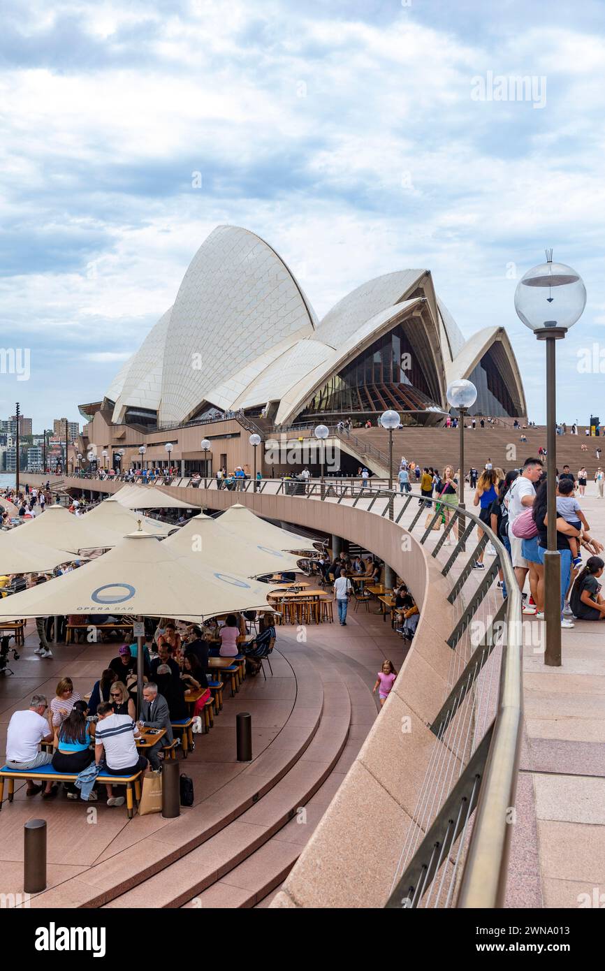 Sydney Opera House building, 2024, at bennelong point in Sydney with people enjoying lunch at Sydney opera house bar and restaurant, iconic Stock Photo