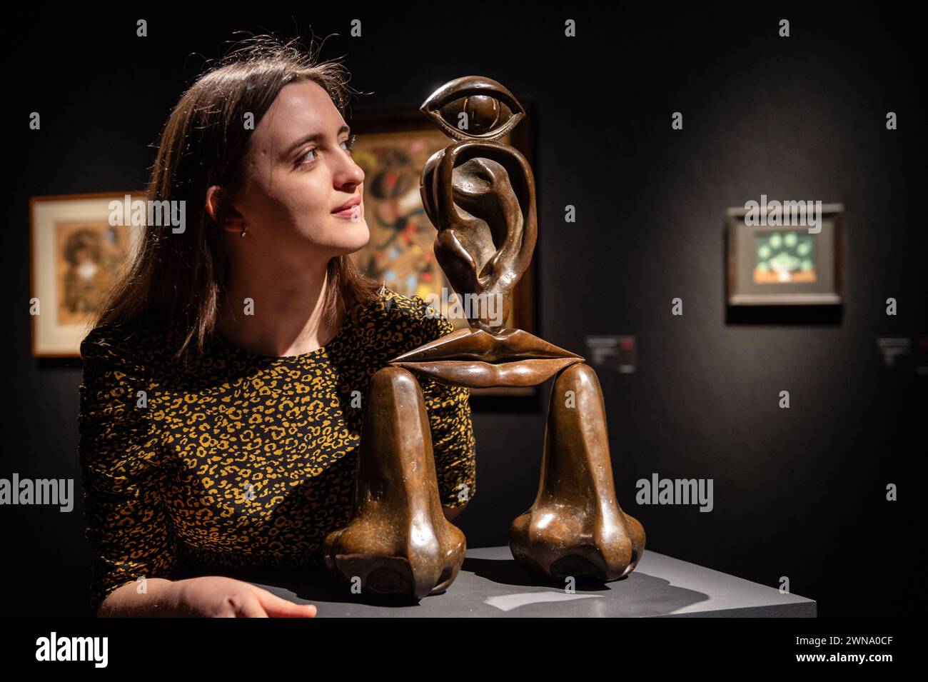 London, England, UK. 1st Mar, 2024. Christie's staff member looks at Rene Magritte's ''La race blanche, '' estimated at GBP 300,000 - 500,000, during the press preview of Christie's '20th/21st Century London Evening Sale' and 'The Art of The Surreal Evening Sale'. The sales will take place on the evening of March 7. (Credit Image: © Thomas Krych/ZUMA Press Wire) EDITORIAL USAGE ONLY! Not for Commercial USAGE! Stock Photo