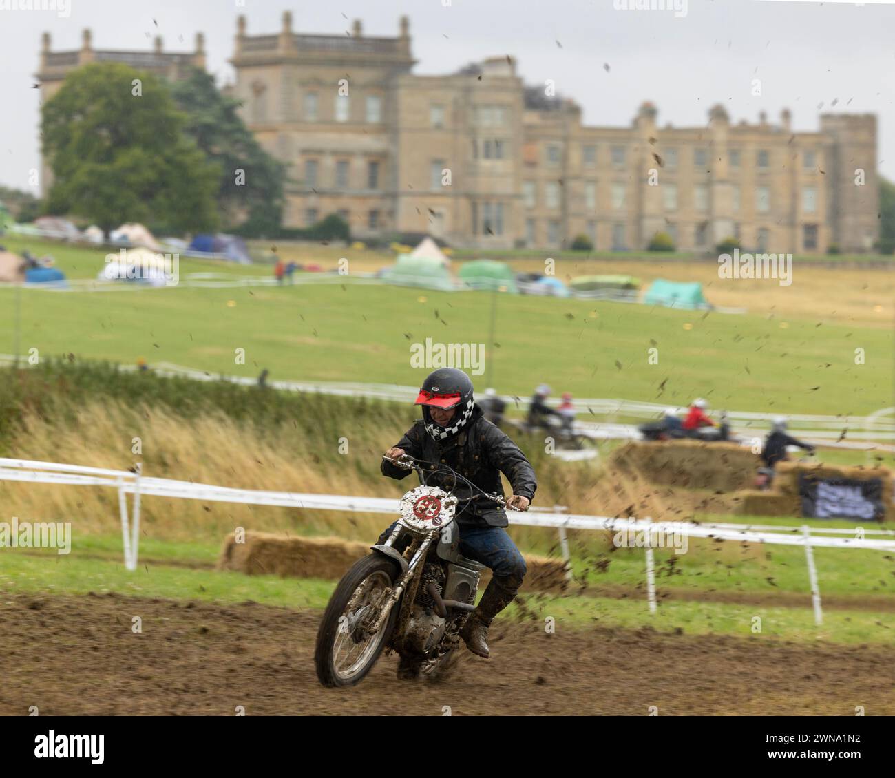 Competitors brave torrential rain and slippery mud & play moto polo at the Malle Mile Festival at Grimsthorpe Castle, Lincolnshire. Stock Photo