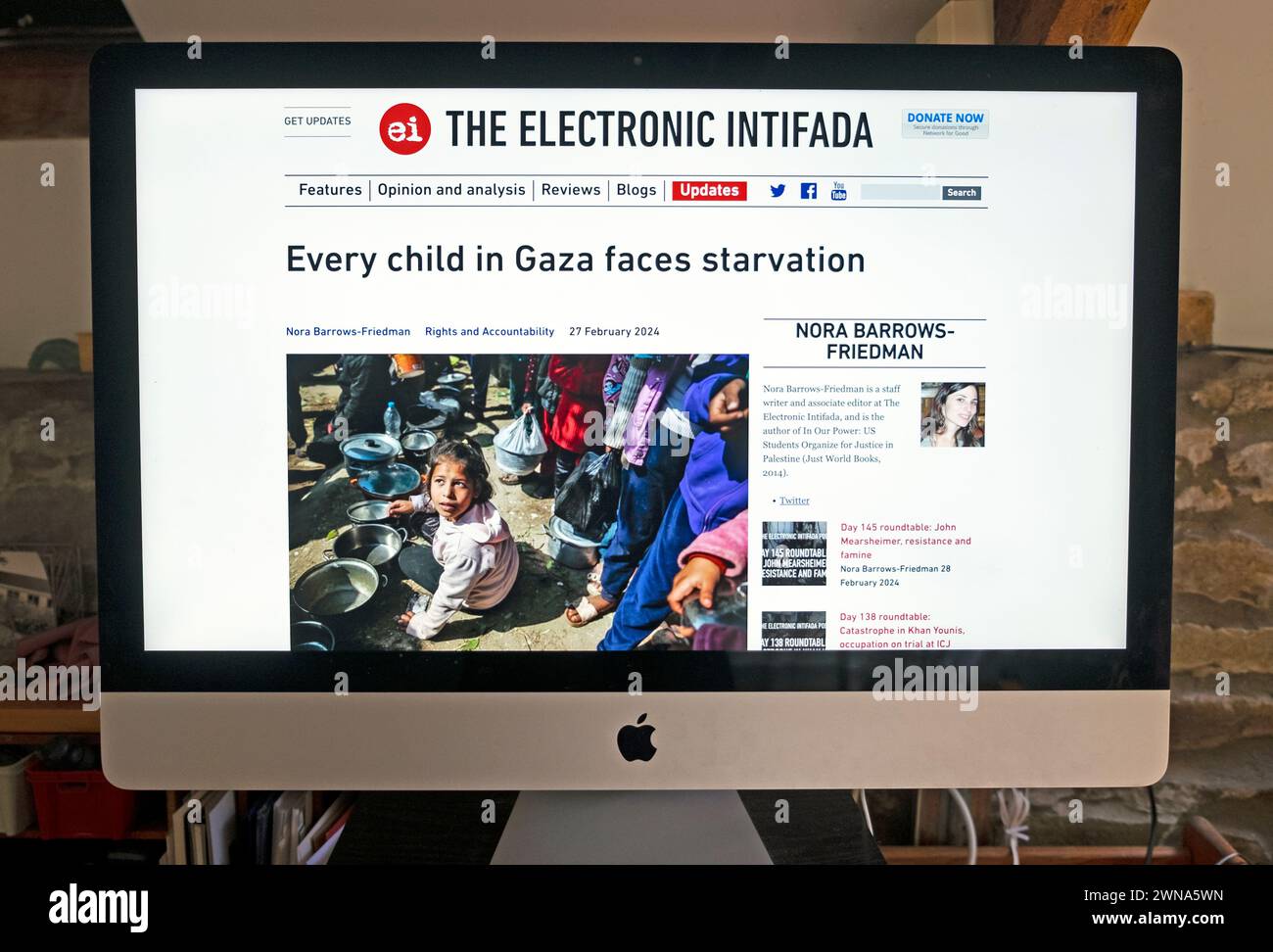 'Every child in Gaza faces starvation' screenshot of The Electronic Intifada online website computer screen Israel Hamas war article 27 February 2024 Stock Photo